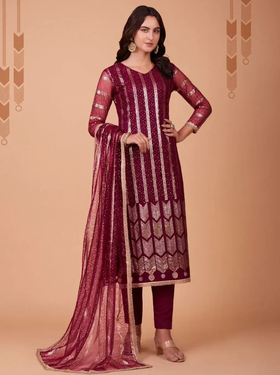 Maroon ethnic salwar kameez with gold embroidery and sheer dupatta, perfect for Indian festive occasions