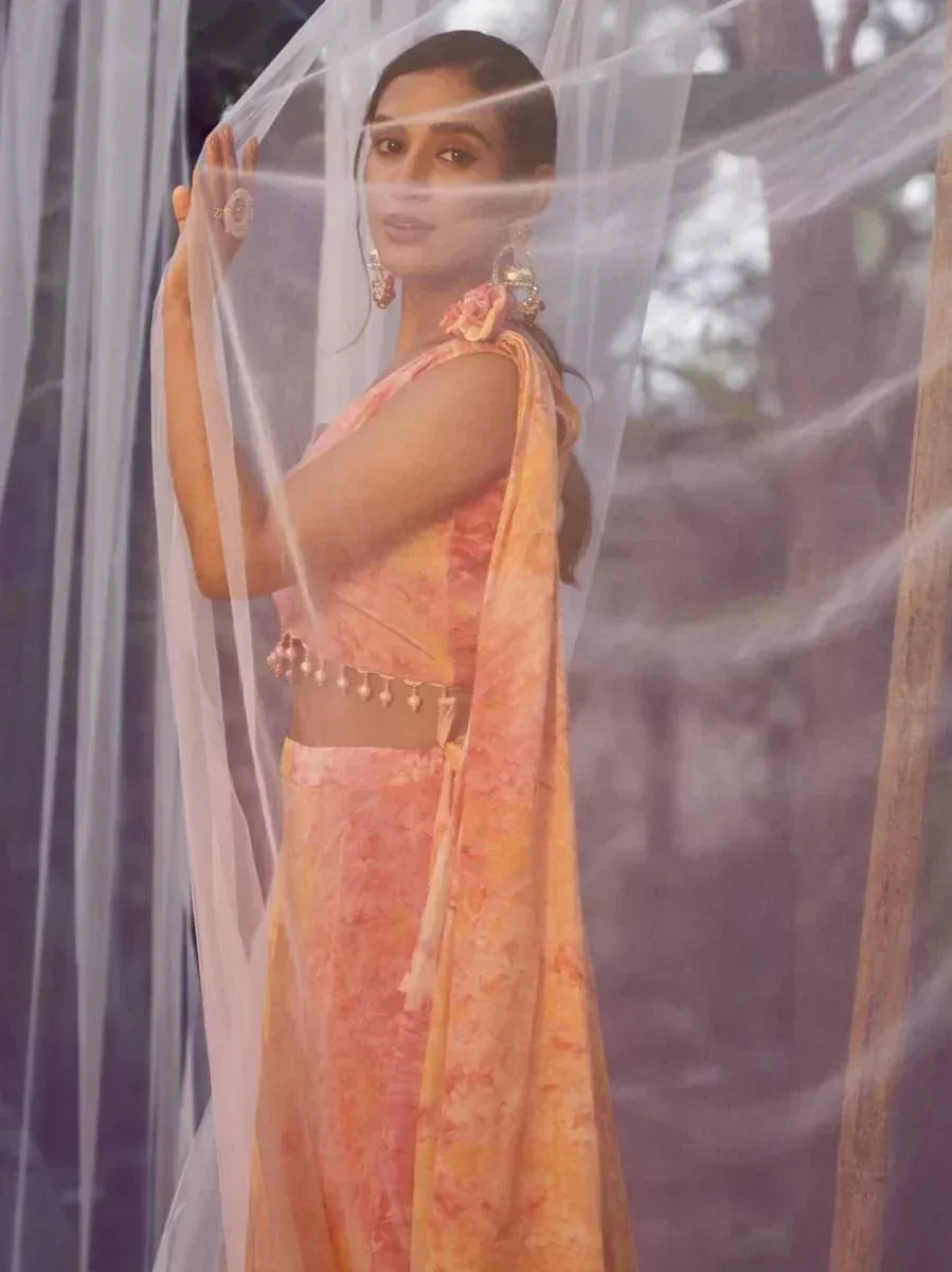 Woman in peach floral lehenga choli with sheer dupatta, ethnic Indian wear