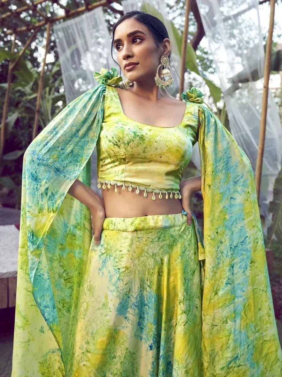 Vibrant green and blue tie-dye lehenga choli with cape sleeves, perfect for ethnic occasions