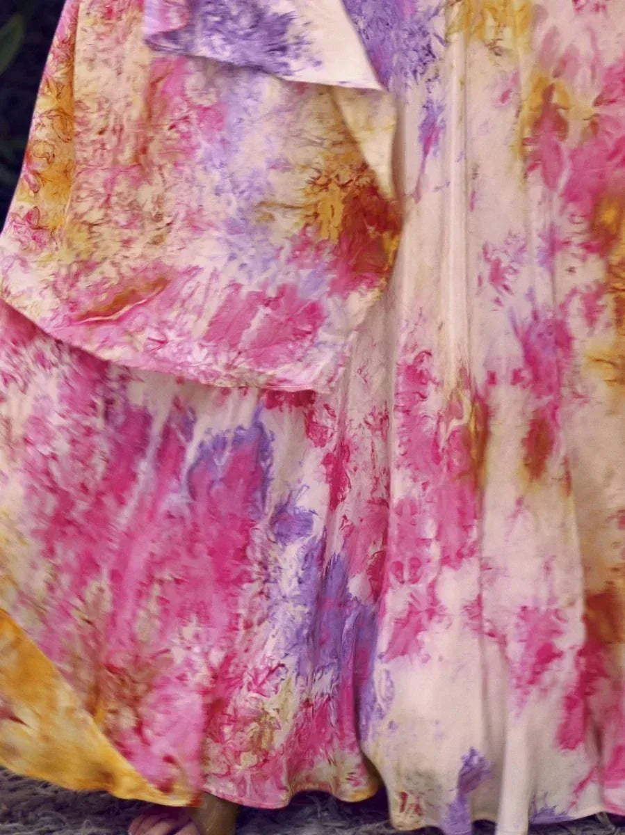 Vibrant tie-dye ethnic gown in pink, purple, and yellow hues, perfect for festive occasions.