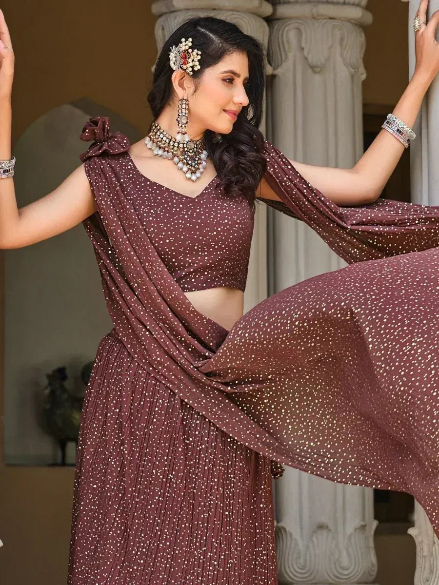 Elegant maroon polka dot lehenga choli with floral hair accessory and traditional jewelry