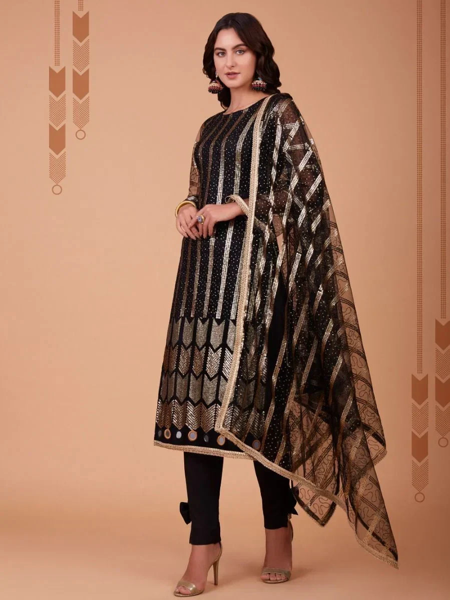 Woman in black and gold embroidered salwar kameez with matching sheer dupatta