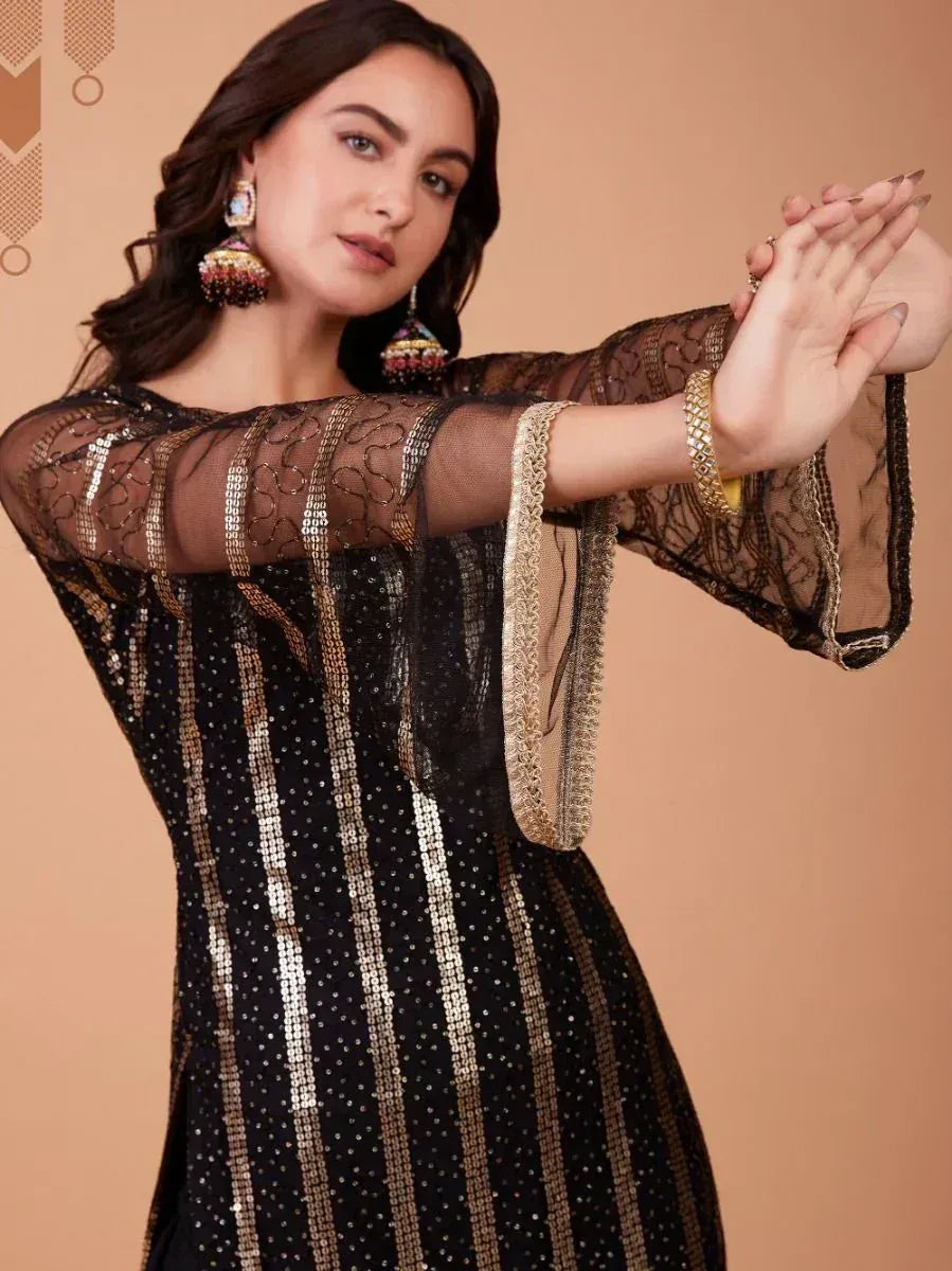 Black and gold sequin ethnic gown with sheer bell sleeves, perfect for Indian festive occasions.