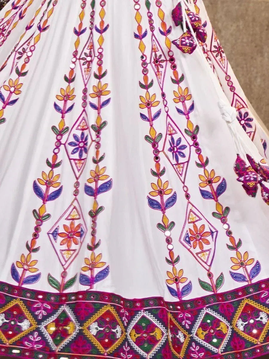 White lehenga with colorful floral embroidery and mirror work, perfect for Indian ethnic wear