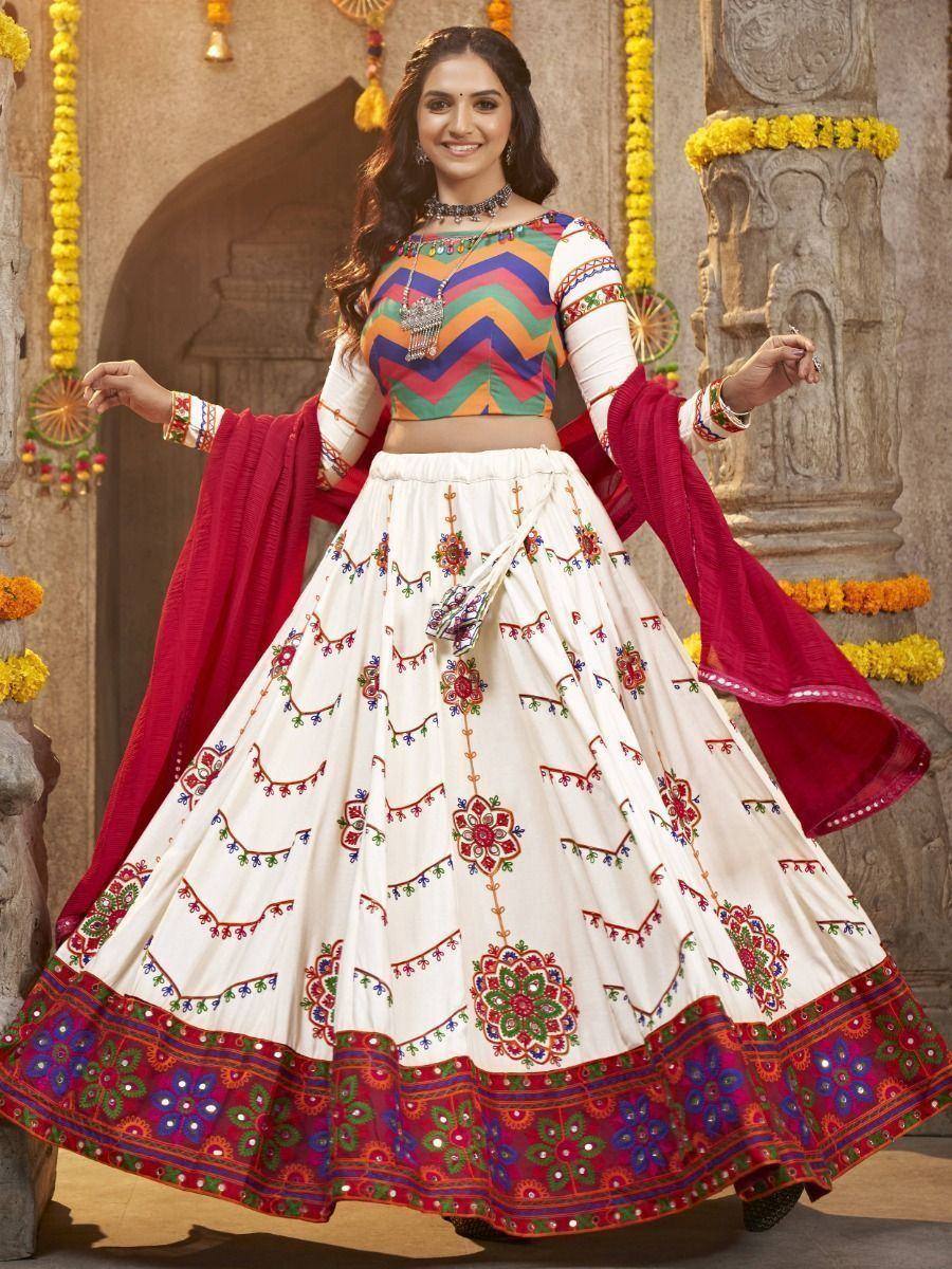 Colorful ethnic lehenga choli with embroidered white skirt, rainbow top, and red dupatta for festive occasions