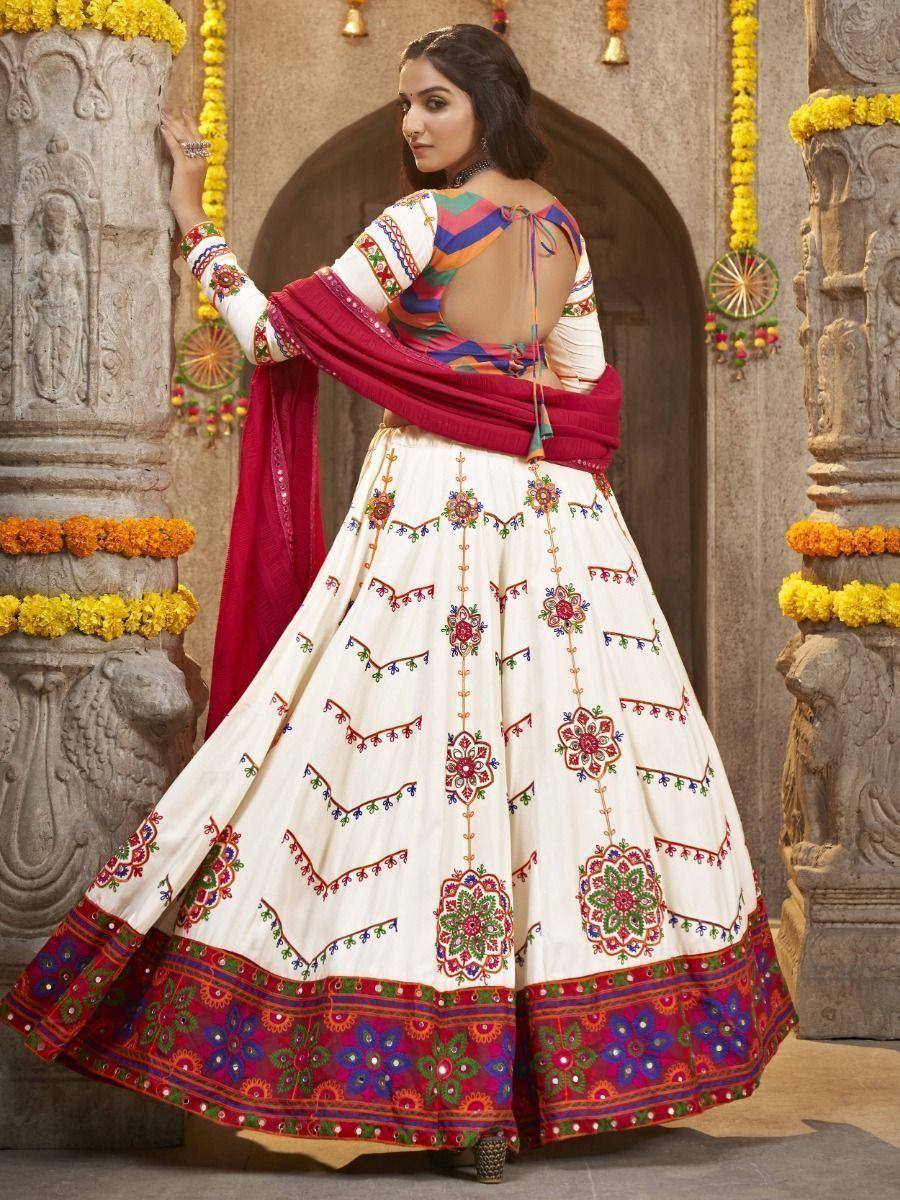 White embroidered lehenga choli with colorful floral patterns and red dupatta, perfect for Indian ethnic wear