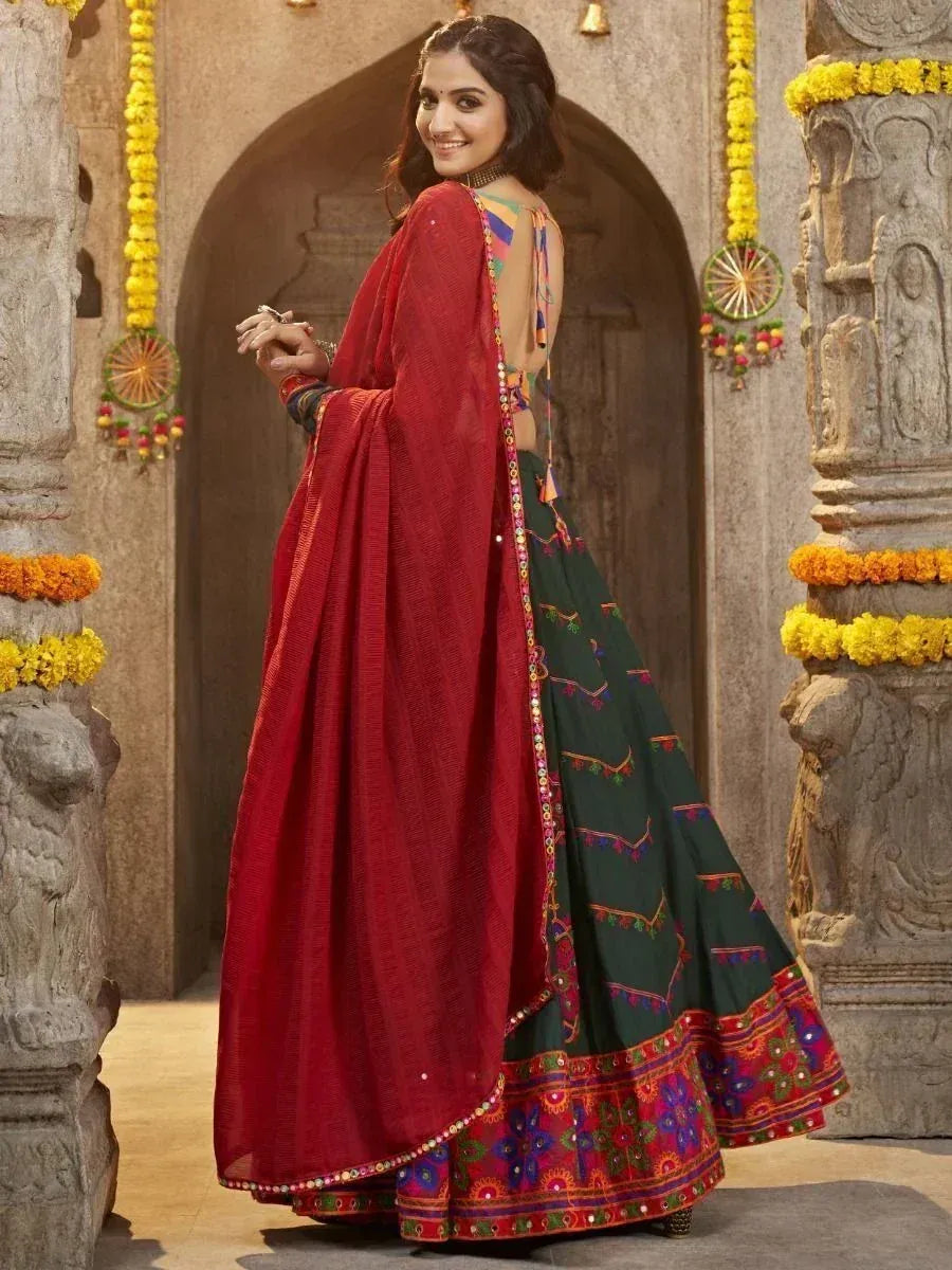 Woman in green embroidered lehenga with red dupatta, traditional Indian ethnic wear for festive occasions