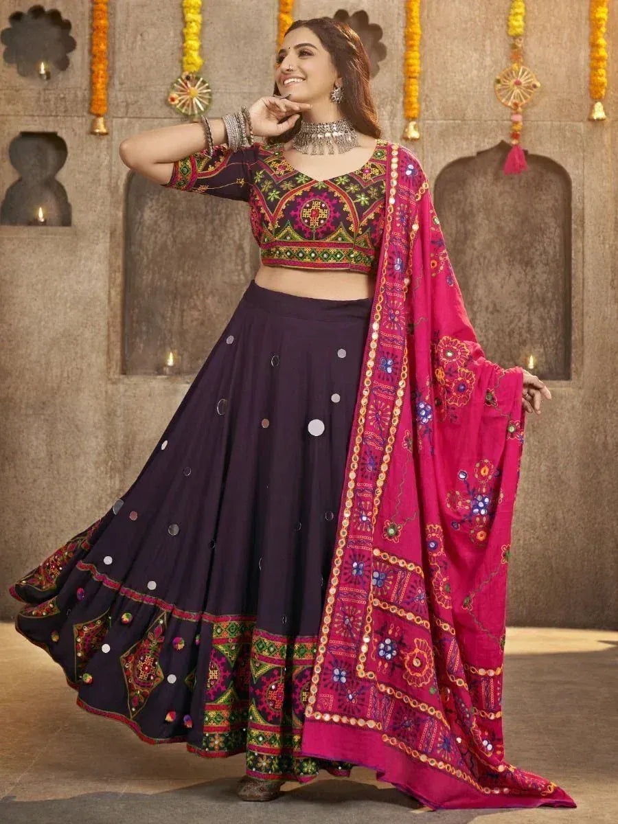 Woman in purple embroidered lehenga choli with pink dupatta, traditional Indian ethnic wear