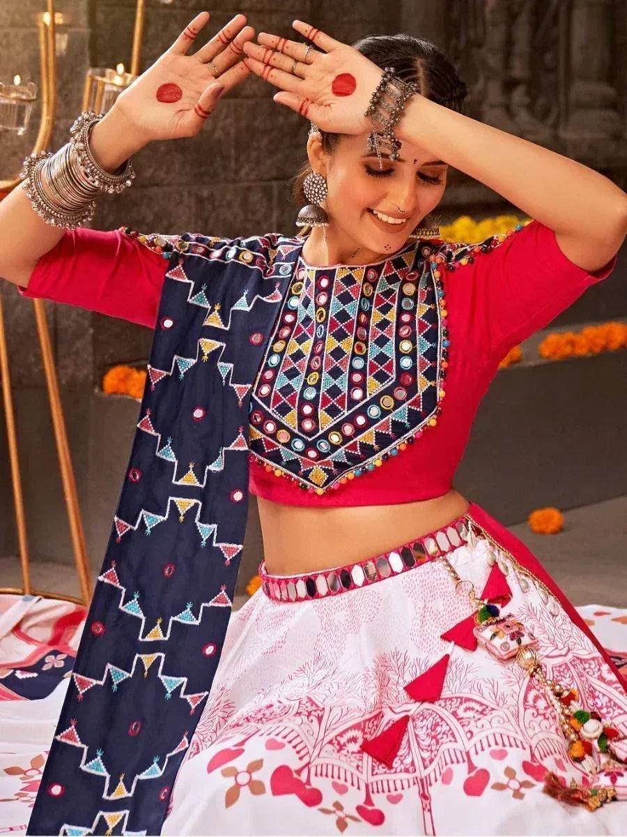 Woman in vibrant Indian ethnic wear with mirror work blouse and printed lehenga, perfect for festive occasions