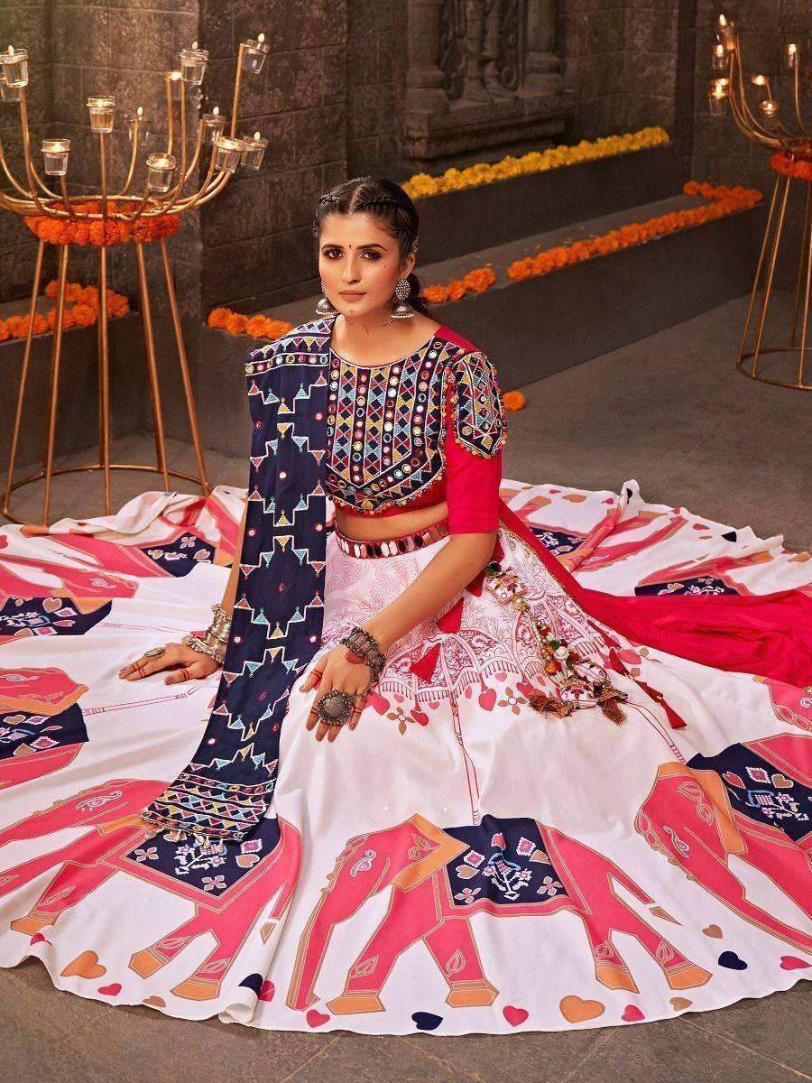 Woman in vibrant Indian lehenga choli with elephant print, perfect for festive occasions and ethnic wear.