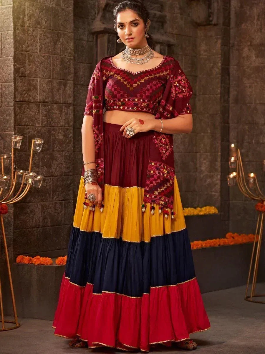 Maroon and yellow embroidered lehenga choli with layered skirt, perfect for Indian ethnic occasions