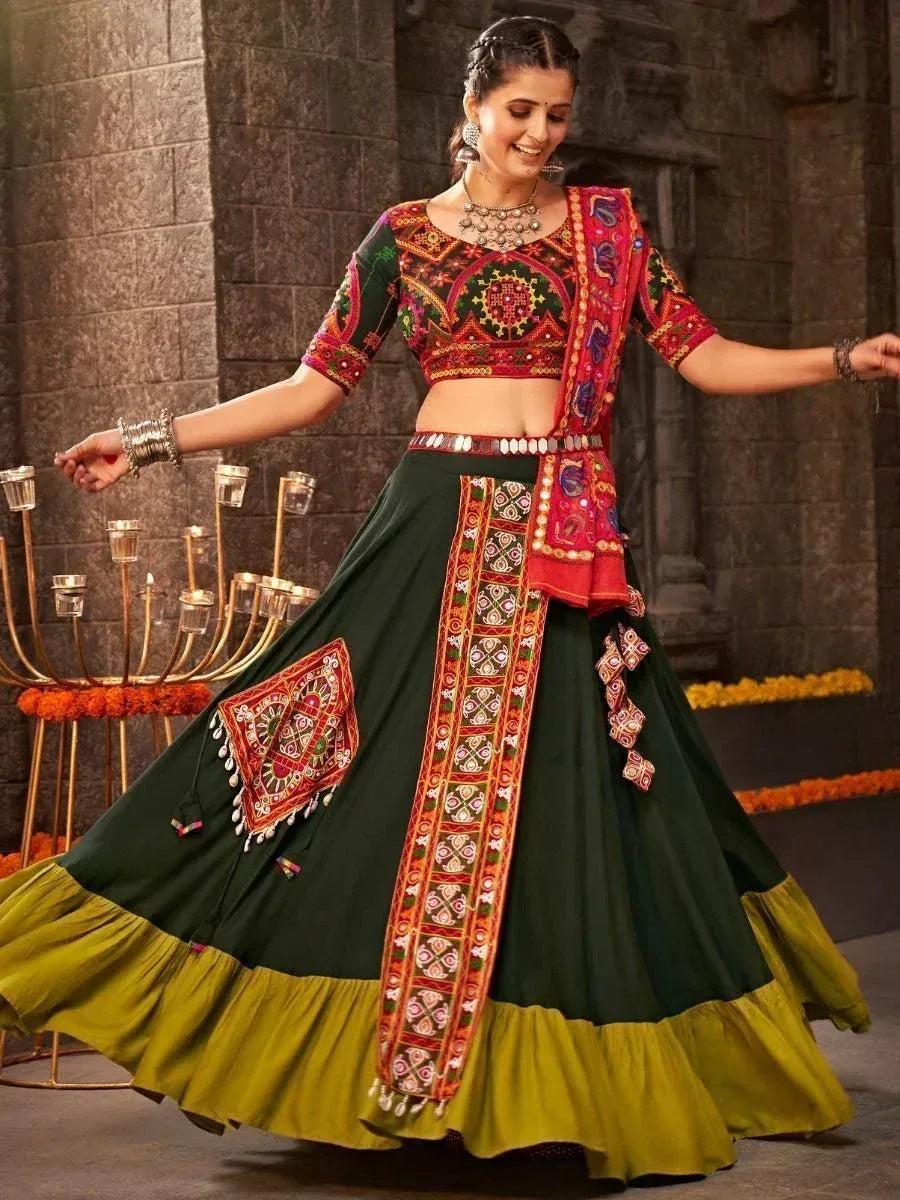 Woman in vibrant green and red embroidered lehenga choli with mirror work, perfect for Indian ethnic occasions