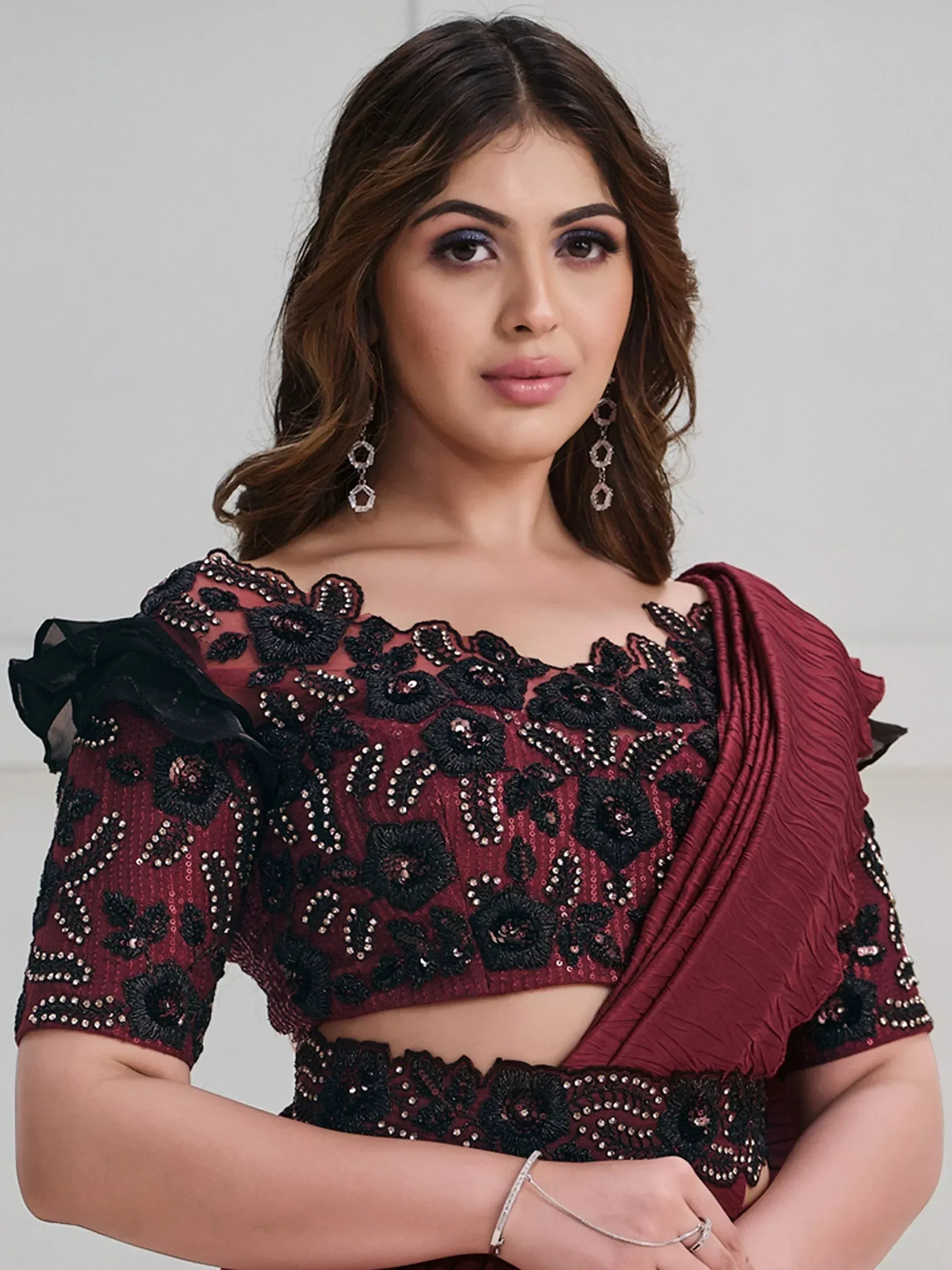 Maroon and black embroidered saree blouse with floral beadwork, off-shoulder design, and ruffled sleeves