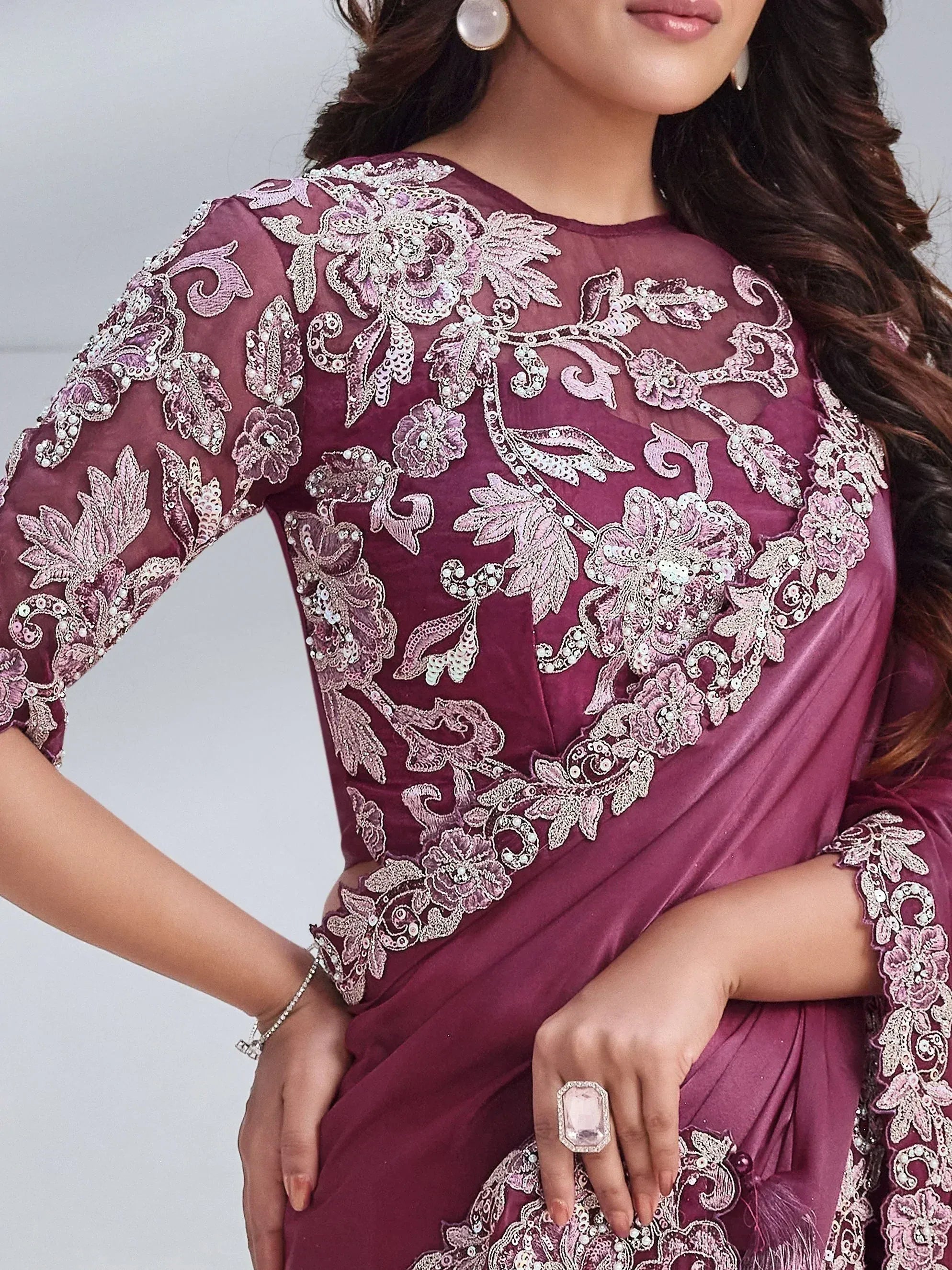 Elegant maroon saree with intricate floral embroidery and sequin detailing, perfect for Indian ethnic occasions.