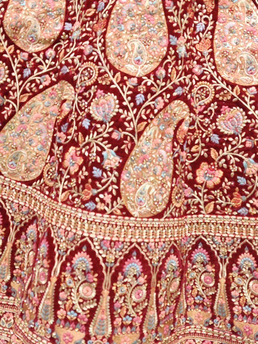 Richly embroidered maroon ethnic wear with paisley and floral motifs, perfect for Indian celebrations