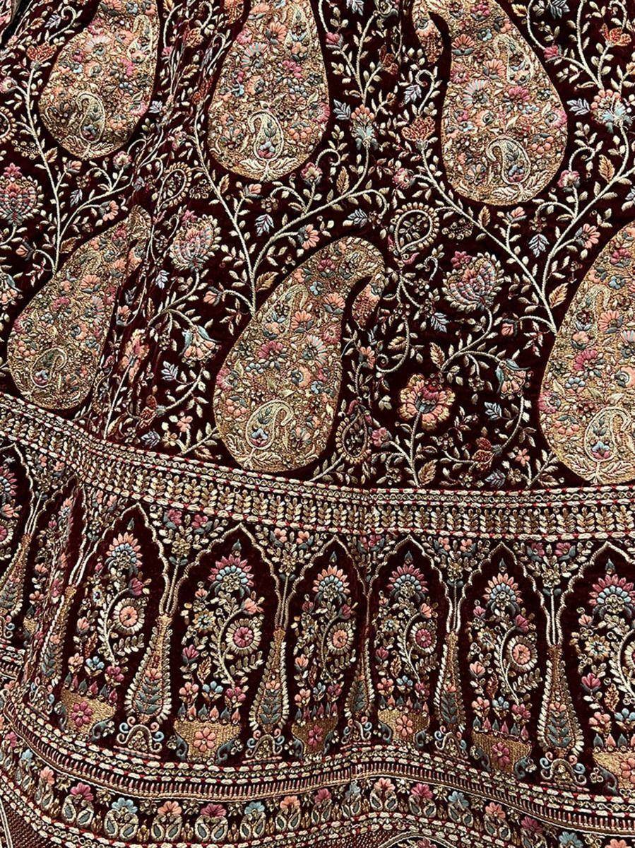 Richly embroidered Indian ethnic wear with paisley and floral motifs in deep maroon