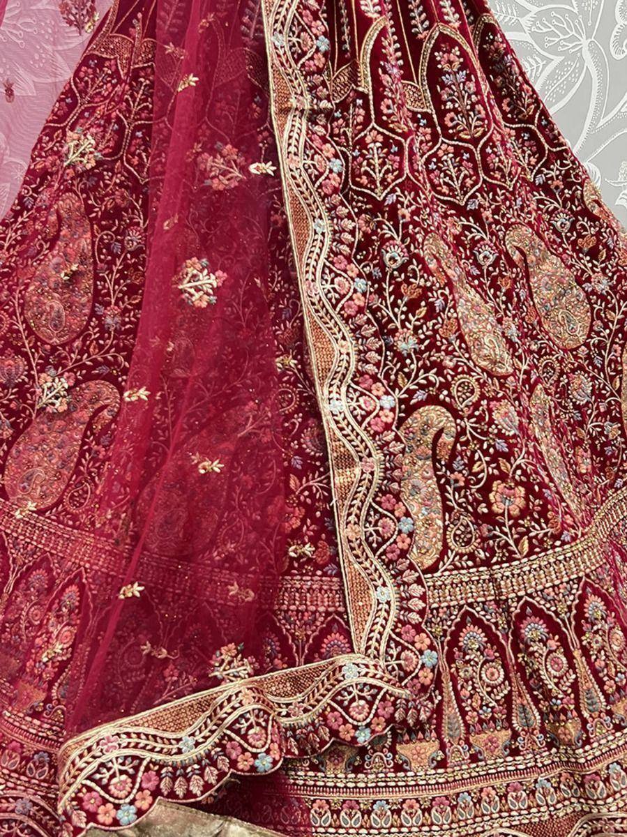 Rich maroon lehenga choli with intricate floral and paisley embroidery, perfect for Indian ethnic wear.