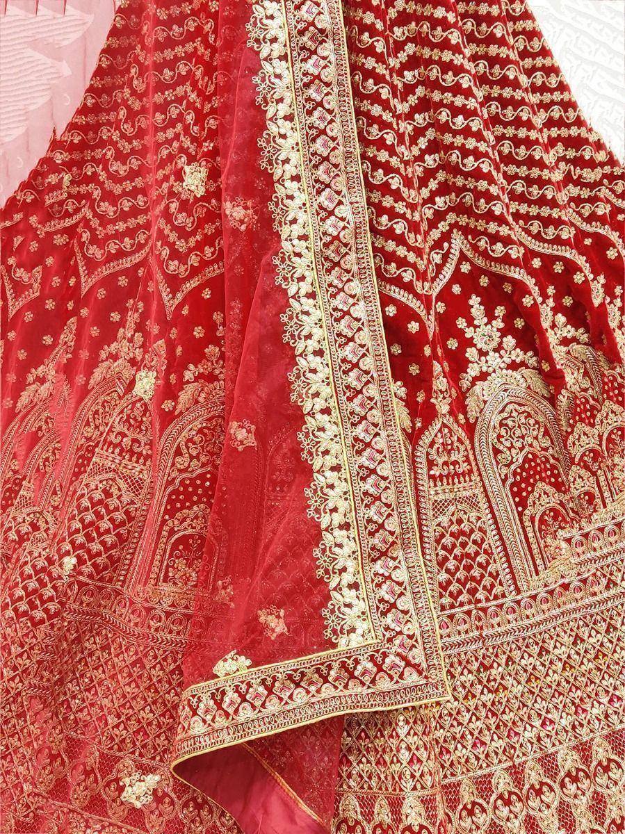 Red velvet lehenga with gold embroidery and detailed border, perfect for Indian weddings and festive occasions.
