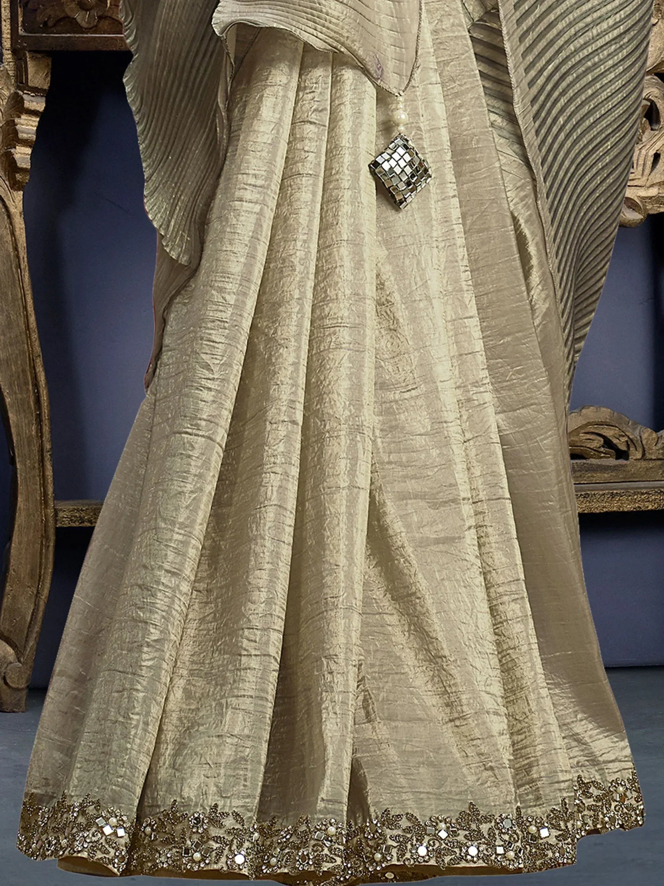 Beige ethnic gown with mirror work and embroidered hem, perfect for Indian occasions