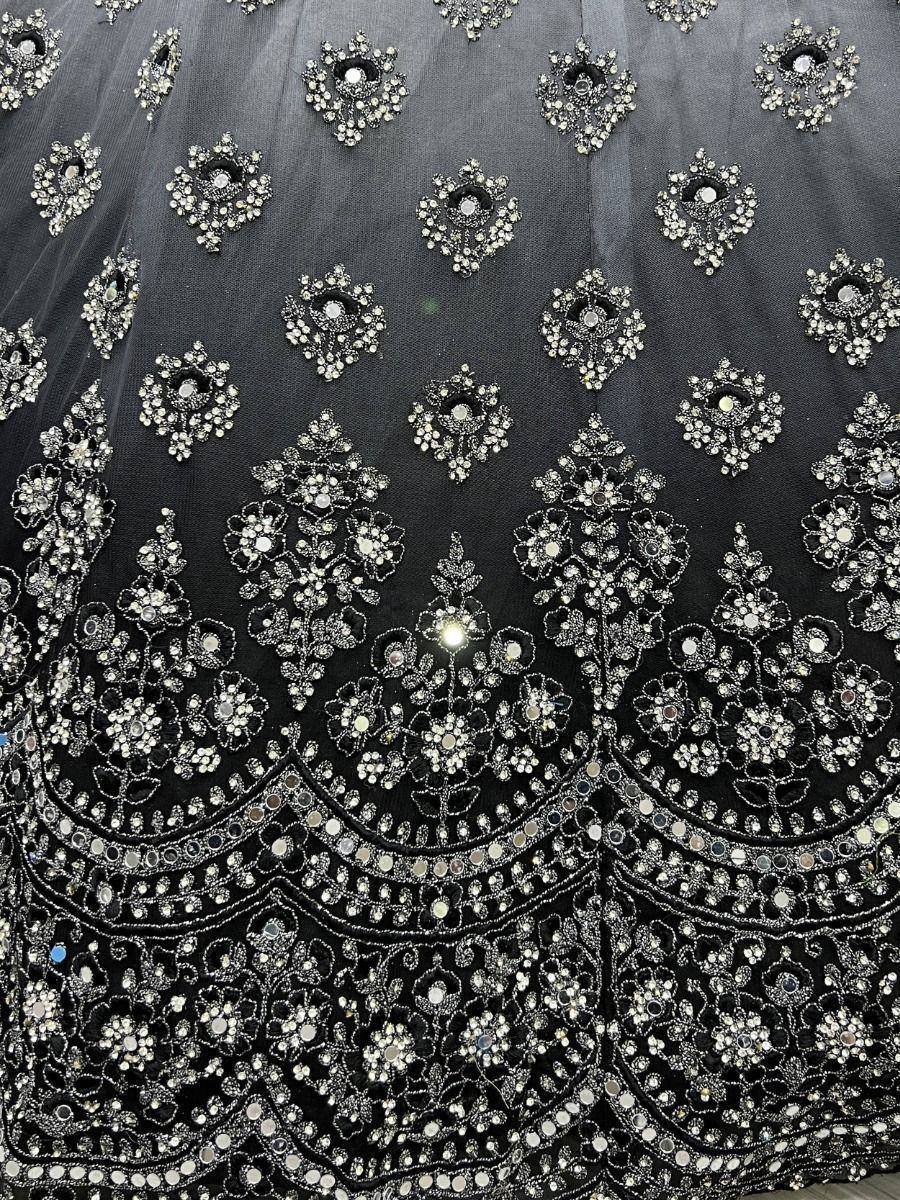 Black lehenga with intricate silver embroidery and mirror work, perfect for Indian ethnic wear