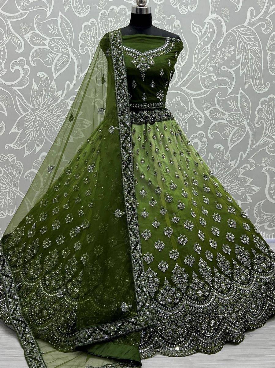 Emerald green designer lehenga choli with heavy silver embroidery and net dupatta, perfect for weddings and festive occasions.