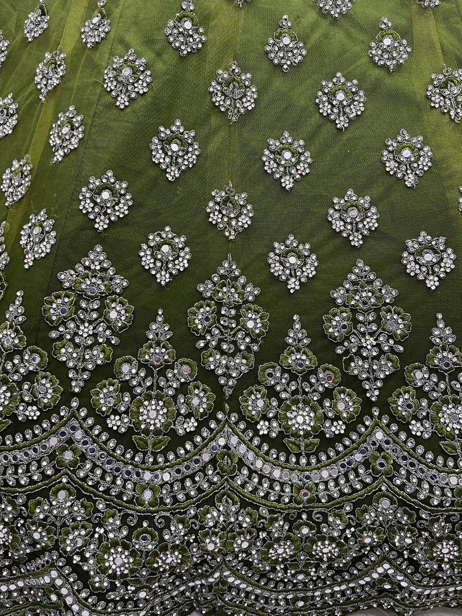 Emerald green lehenga with intricate silver mirror and stone embroidery, perfect for Indian ethnic wear.