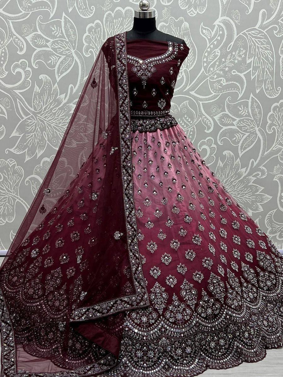 Maroon designer lehenga choli with heavy silver embroidery and net dupatta, perfect for weddings and festive occasions.