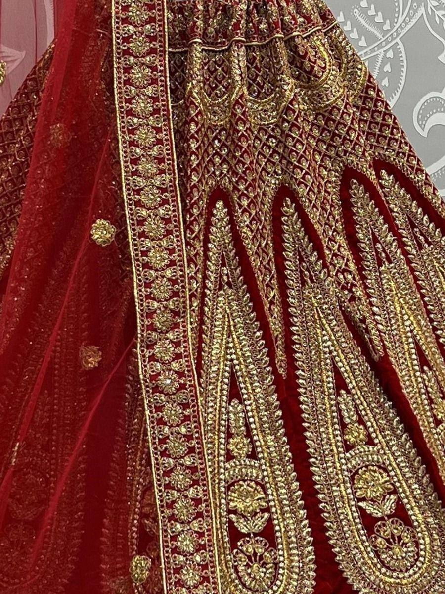 Red velvet lehenga with gold embroidery and sequin detailing, perfect for Indian weddings and festive occasions