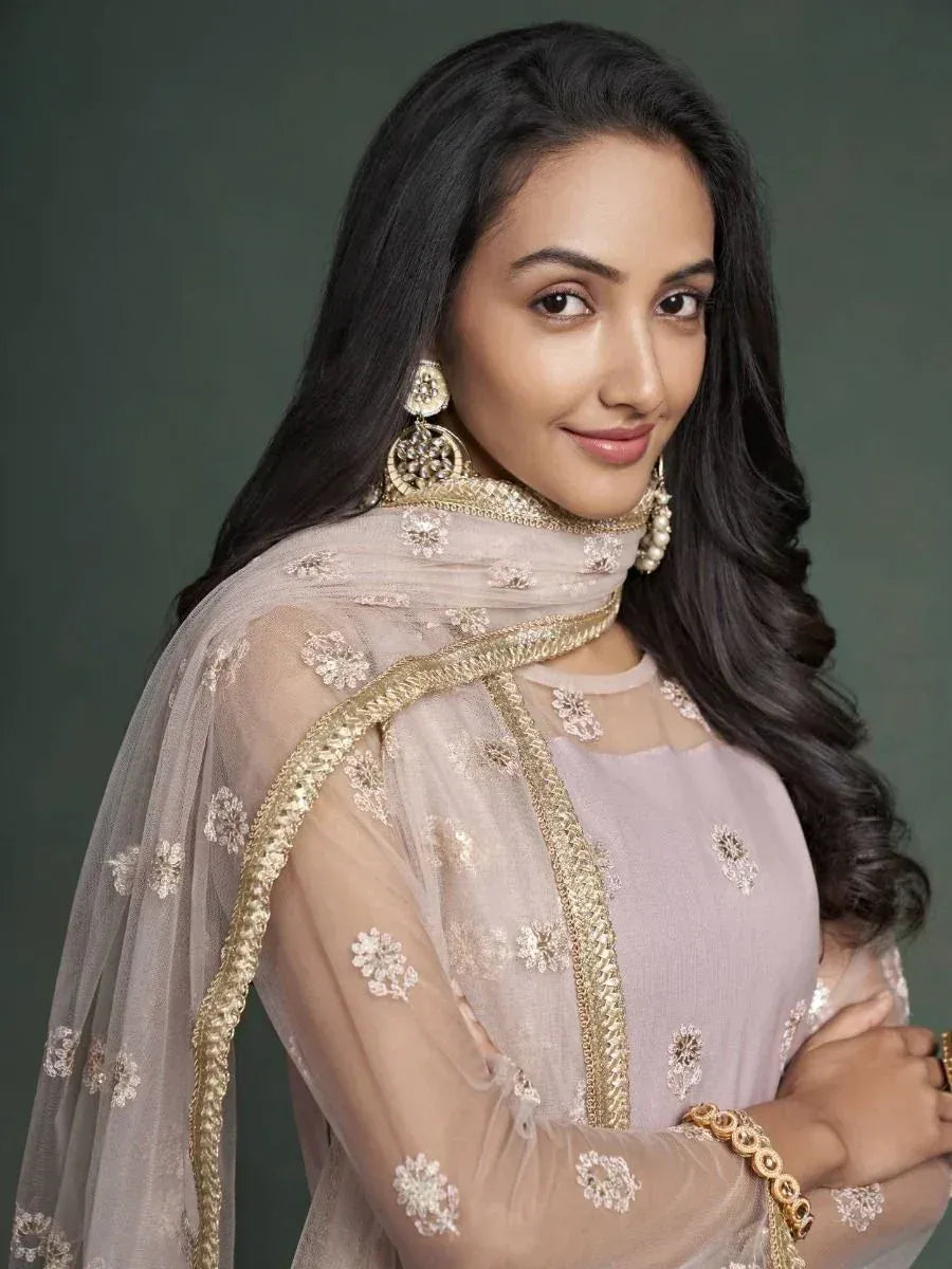 Elegant Indian ethnic wear with floral embroidery and gold trim, perfect for festive occasions.