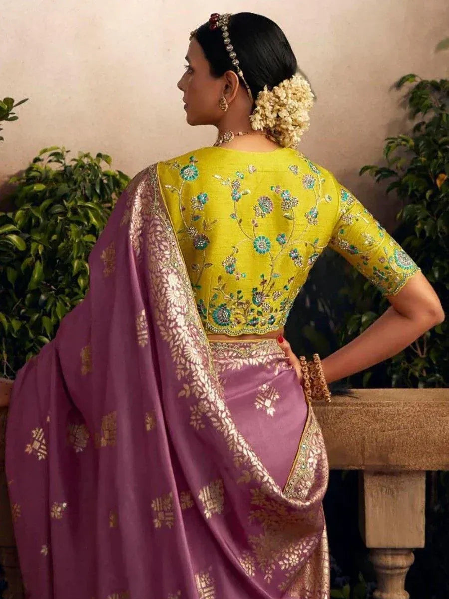 Woman in purple saree with gold embroidery and yellow floral blouse, traditional Indian ethnic wear