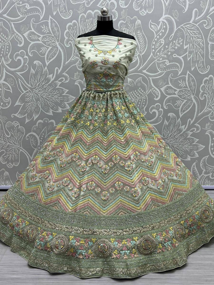 Pastel green designer lehenga choli with floral embroidery and zigzag patterns, ethnic Indian wear