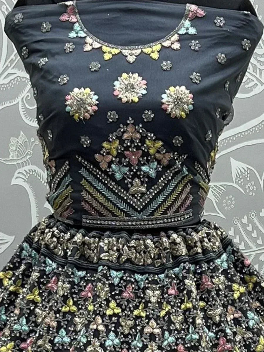 Black designer lehenga choli with colorful floral and butterfly embroidery, perfect for Indian ethnic wear.