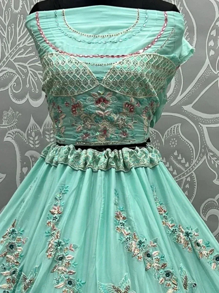 Mint green embroidered lehenga choli with floral detailing and sequin work, perfect for Indian ethnic occasions.