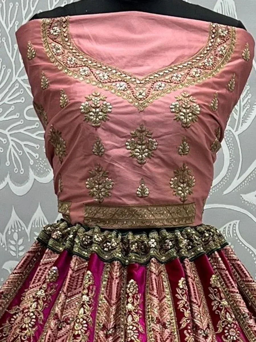 Pink and maroon designer lehenga choli with gold embroidery and embellished neckline