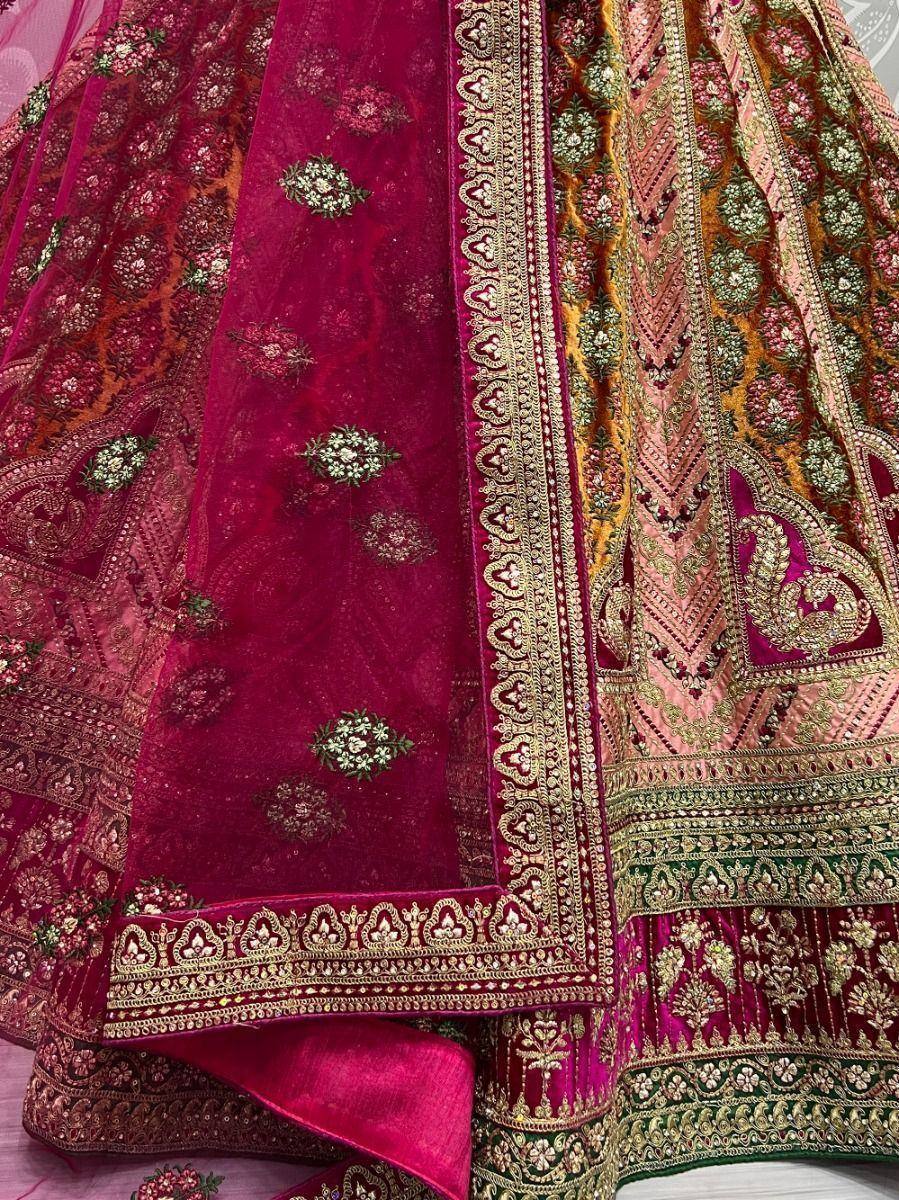 Luxury maroon velvet lehenga with gold embroidery and floral motifs, perfect for weddings and festive occasions.