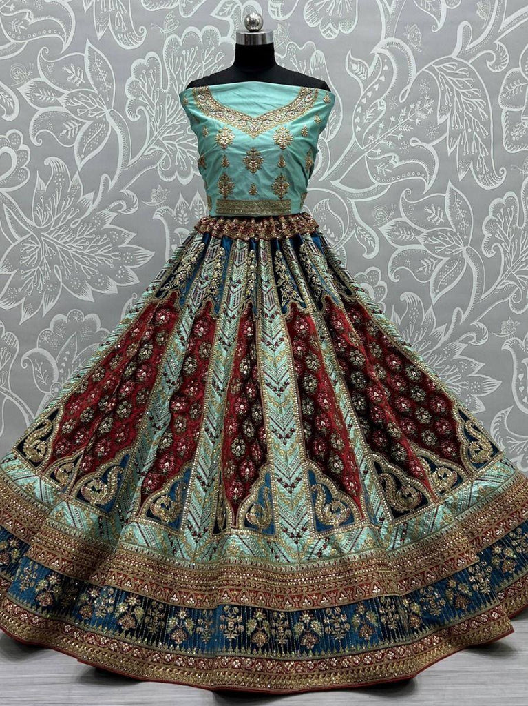 Turquoise and maroon designer lehenga choli with gold embroidery, perfect for Indian weddings and festive occasions.