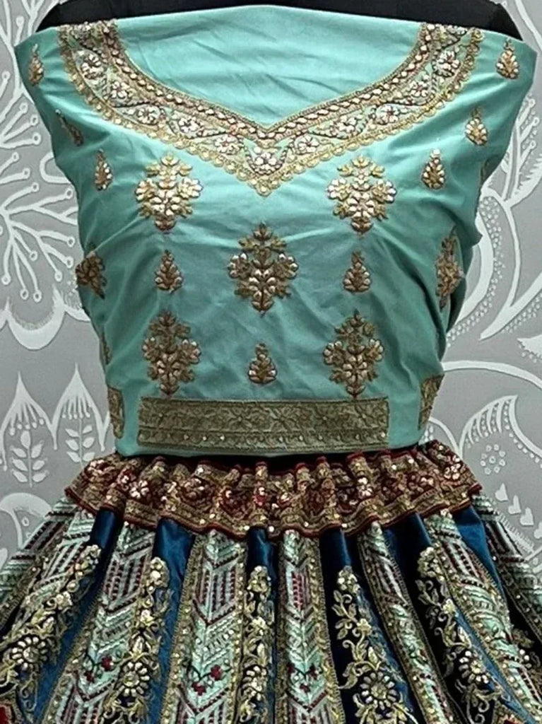 Teal designer lehenga choli with gold embroidery and embellished skirt, ethnic Indian wear