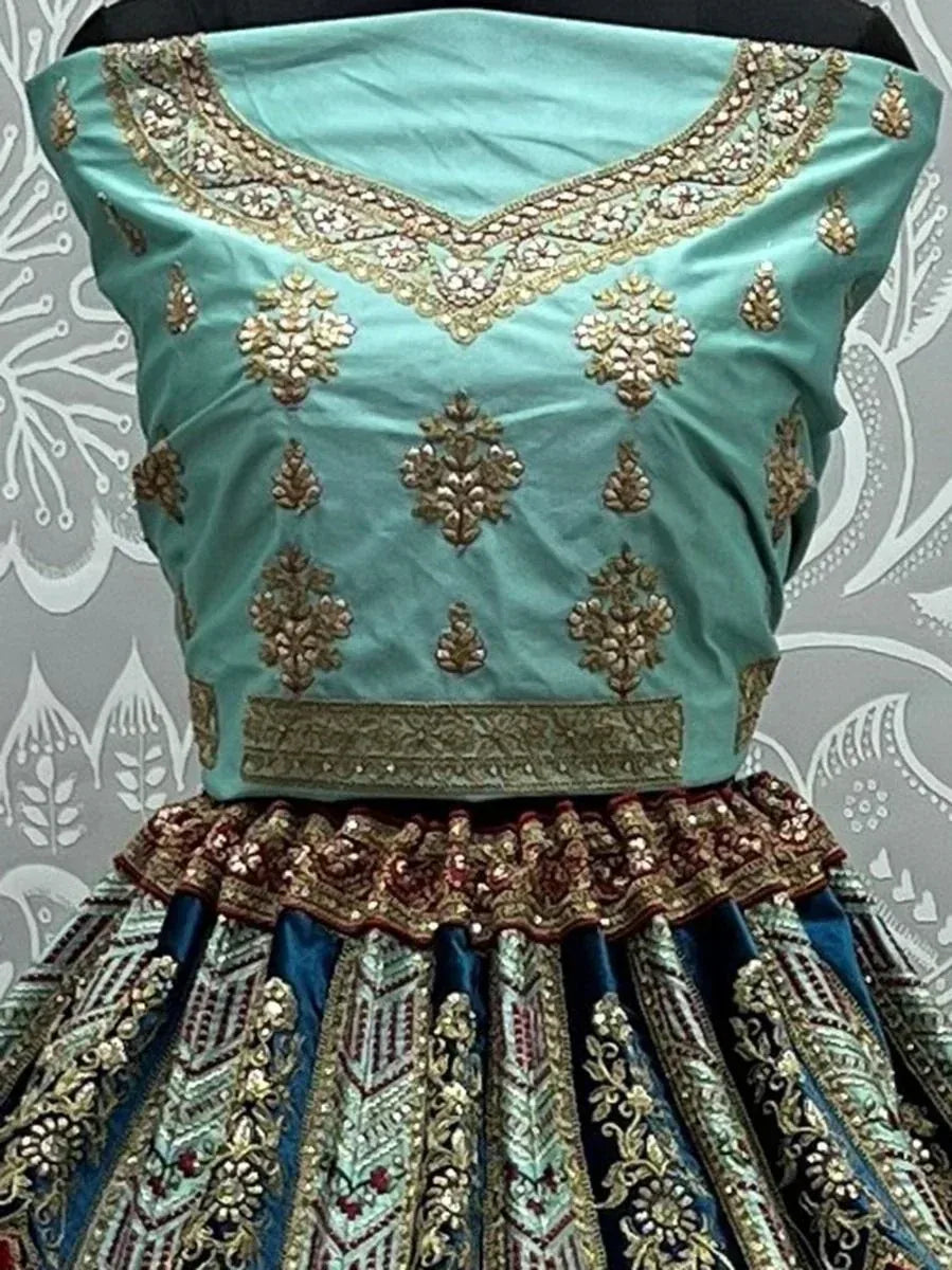 Teal designer lehenga choli with gold embroidery and embellished skirt, ethnic Indian wear