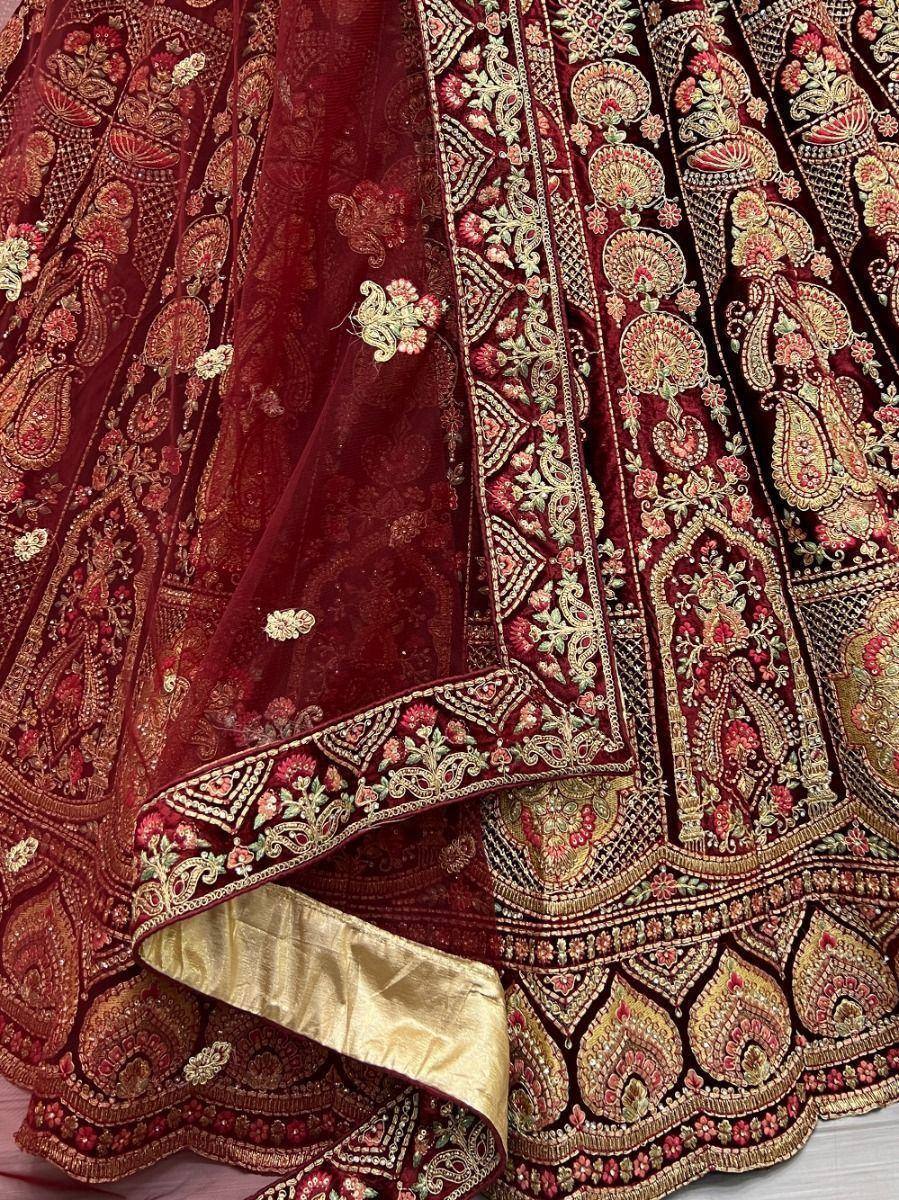 Rich maroon lehenga choli with intricate gold and floral embroidery, perfect for Indian ethnic wear.