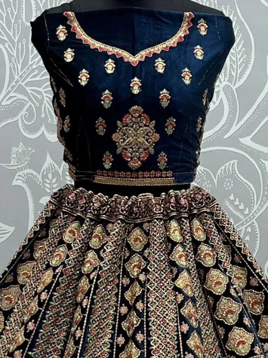 Dark blue embroidered lehenga choli with gold and red floral motifs, perfect for Indian ethnic wear