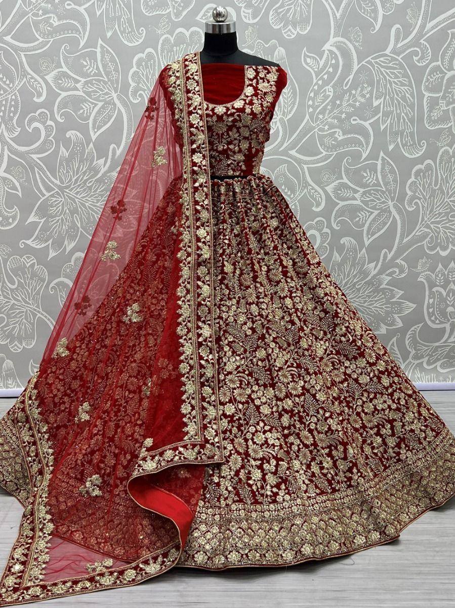 Red and gold embroidered lehenga choli with matching dupatta, perfect for Indian weddings and festive occasions.
