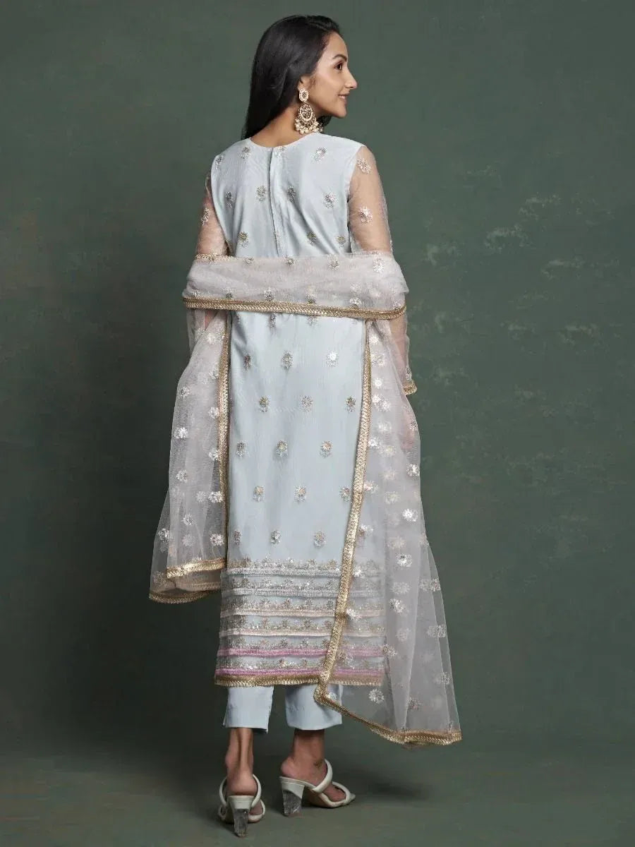 Light blue embroidered salwar kameez with sheer dupatta, gold detailing, and modern heels for ethnic wear
