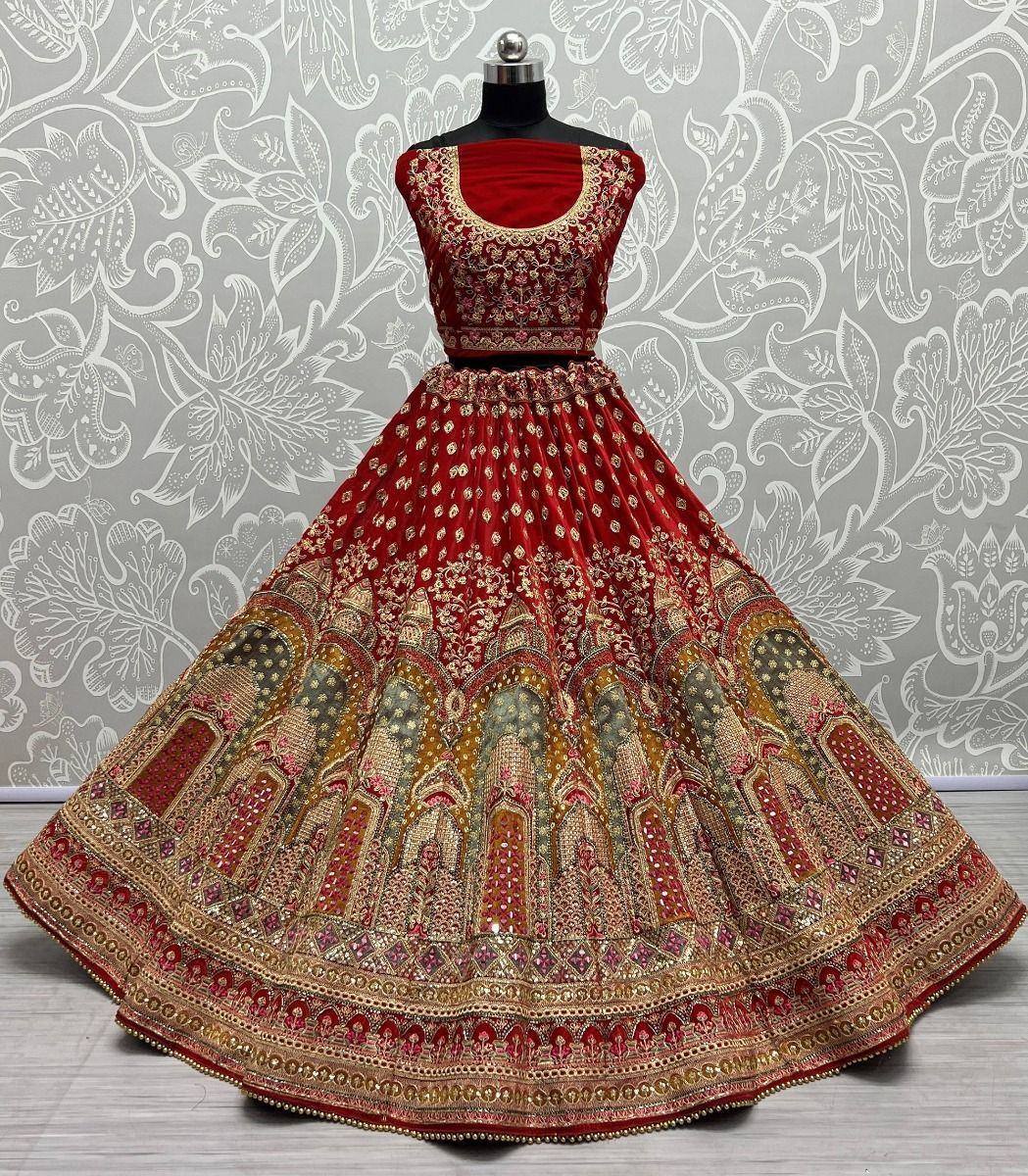 Red embroidered lehenga choli with gold detailing, perfect for Indian weddings and festive occasions.