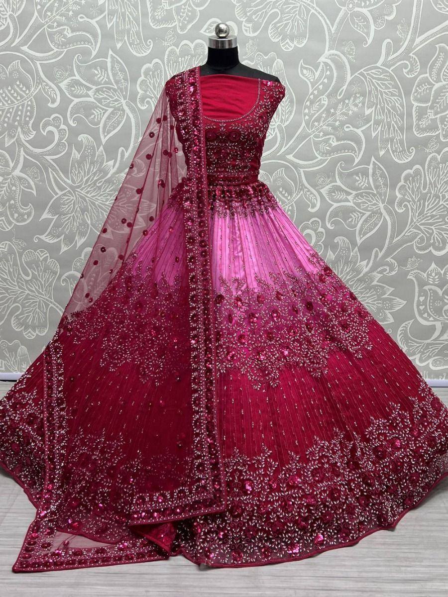 Designer maroon lehenga choli with heavy embroidery and sheer dupatta, perfect for weddings and festive occasions