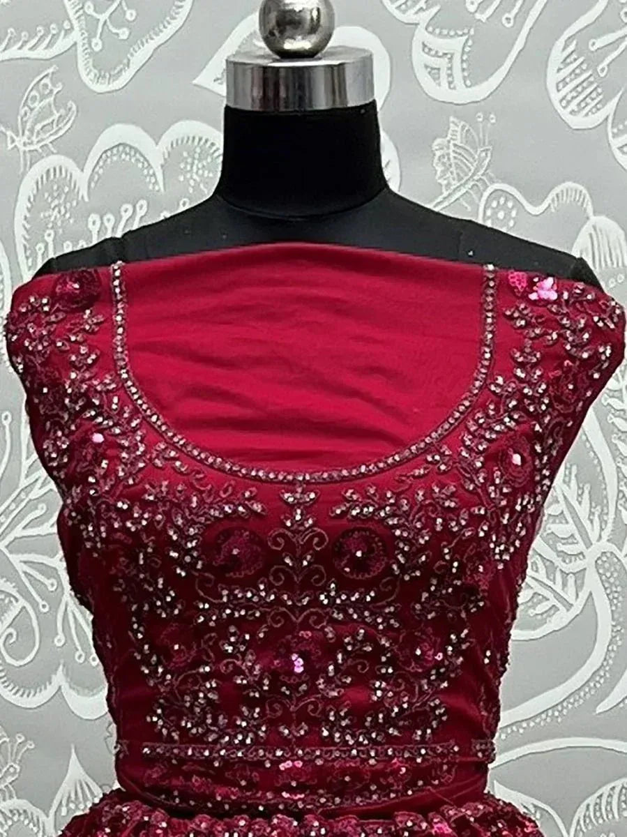 Red velvet designer lehenga choli with intricate beadwork and sequin embroidery, perfect for Indian ethnic wear.