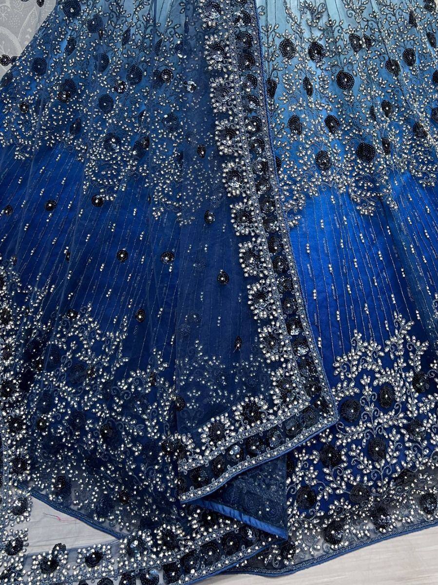 Blue embroidered lehenga choli with intricate silver and black beadwork, perfect for Indian ethnic wear.