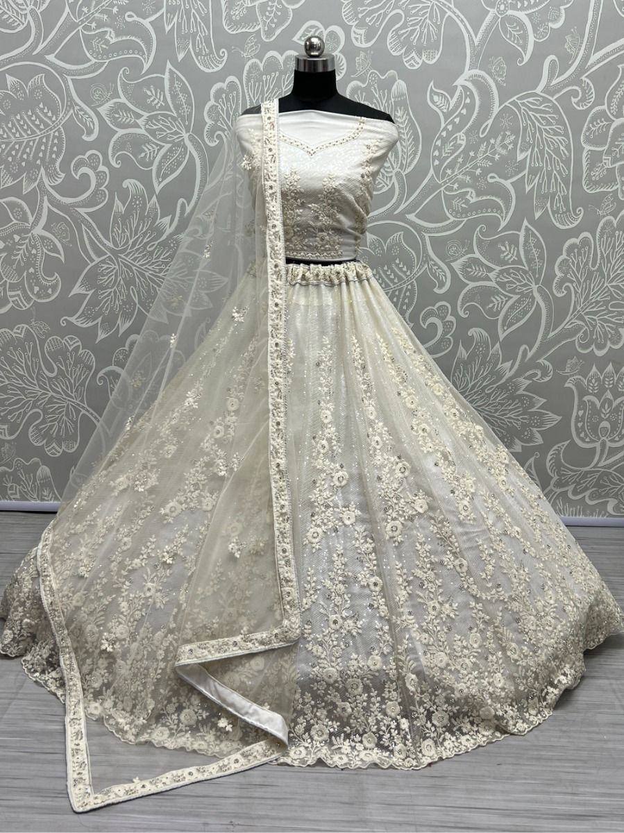 Elegant off-shoulder lehenga choli with floral embroidery and sheer dupatta, perfect for Indian weddings or festive occasions.