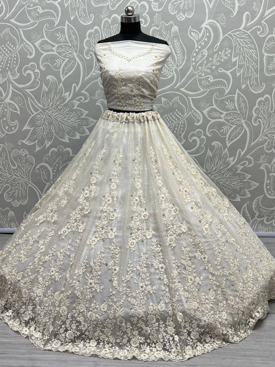 Elegant off-white designer lehenga choli with floral embroidery and net skirt, perfect for Indian weddings.