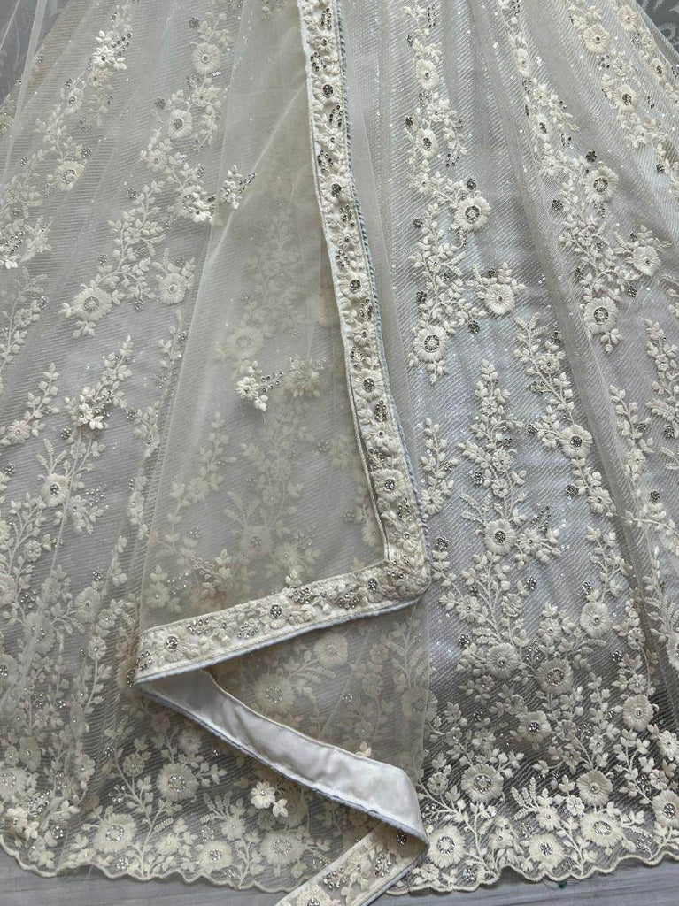 Ravishing Cream Zircon Diamond Work Net Lehenga Choli