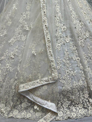 Ravishing Cream Zircon Diamond Work Net Lehenga Choli